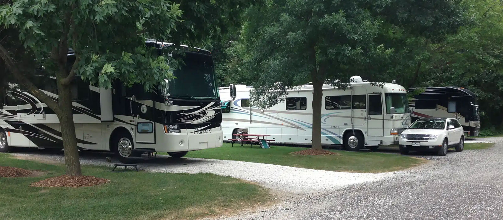 Motorhomes parked among the trees at the Cedar Lake Ministries RV park