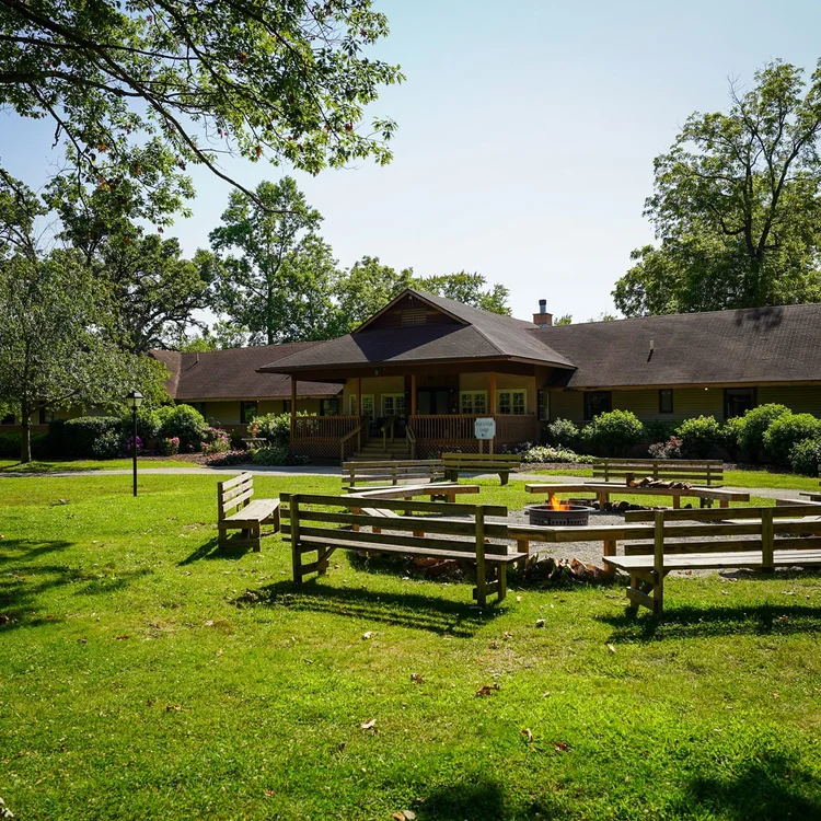 Cabins and RV sites among tall pine trees at camp