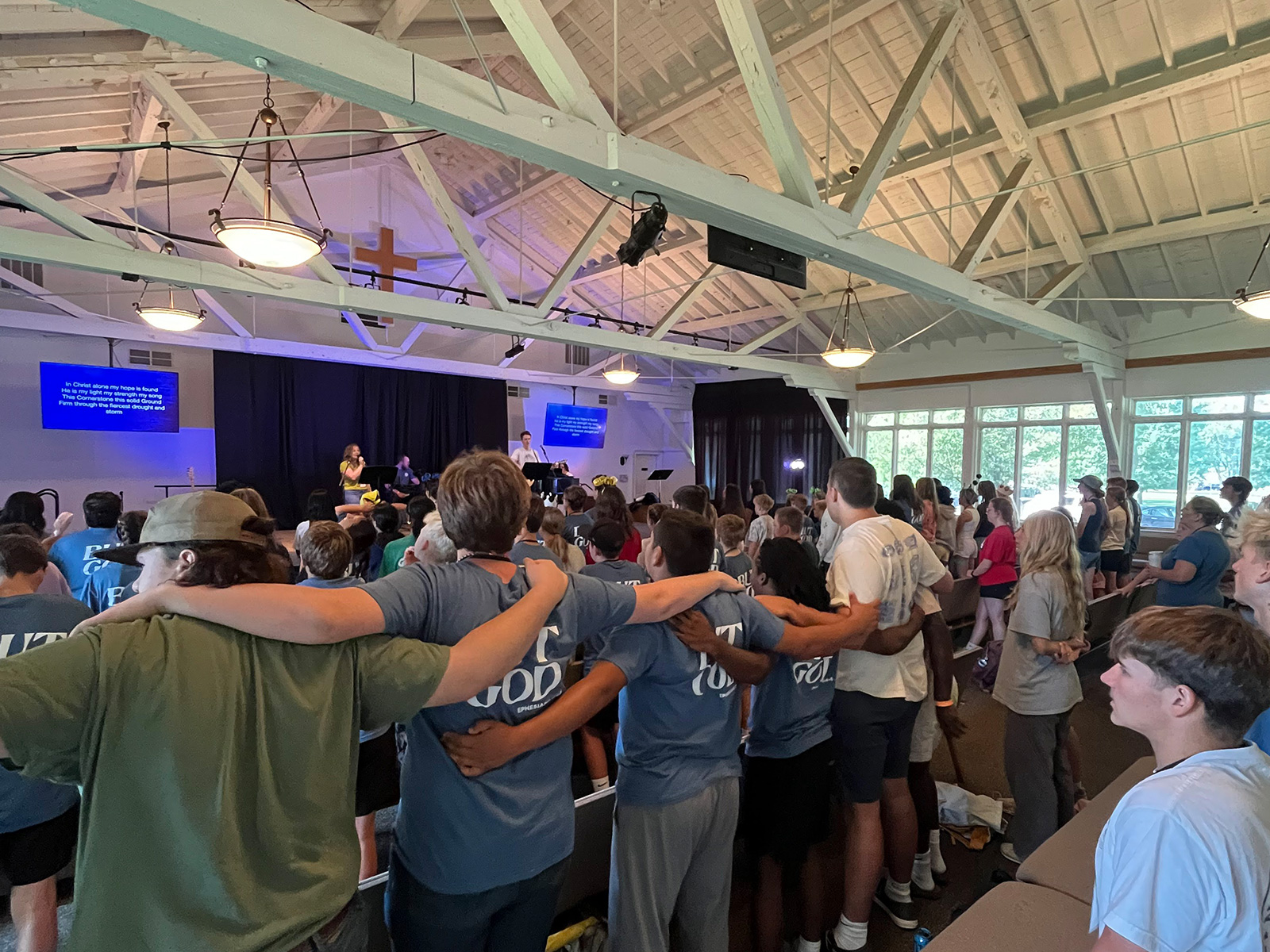Campers worshiping together inside Torrey Auditorium